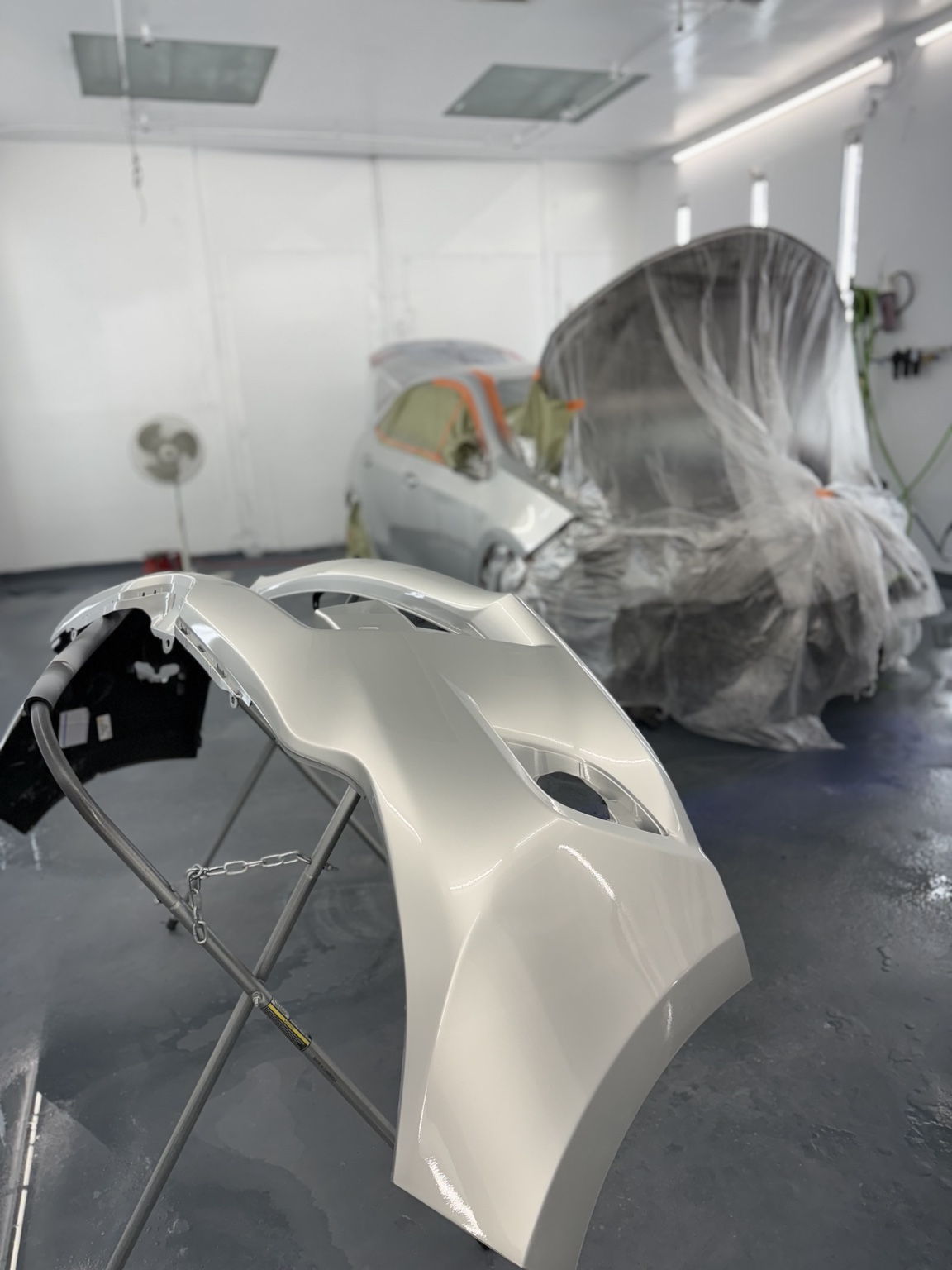 Freshly painted bumper in booth